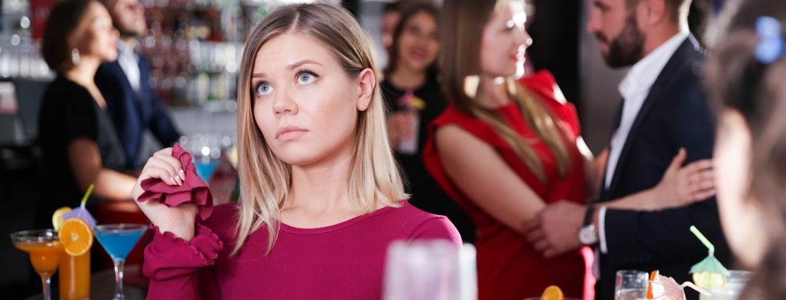 Girl upset because her boyfriend flirting with other woman on Hawaiian party in bar